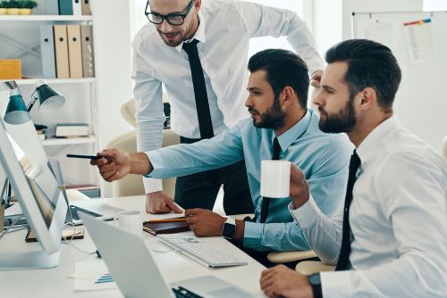 Business men completing Oregon trademark registration on computer..
